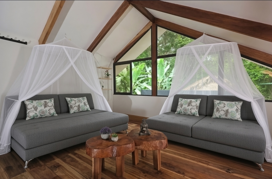 Two sofa beds with mosquito nets in the shared loft