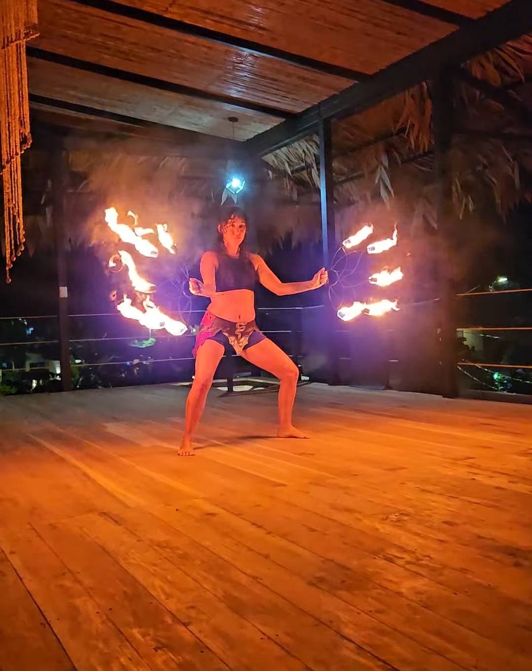 Fire spinning workshop on the open-air ceremony deck at night