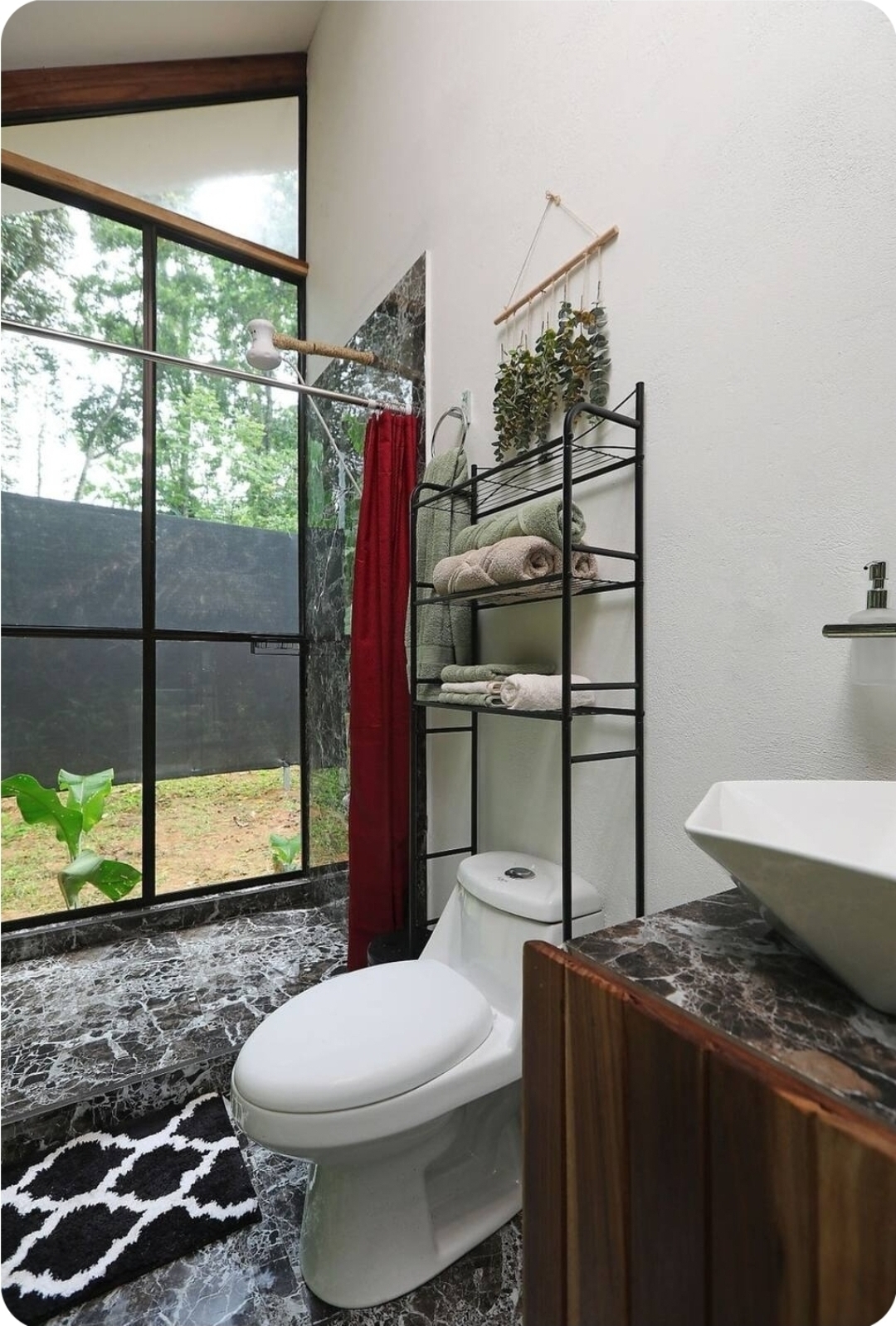 Modern bathroom with floor-to-ceiling jungle-facing window
