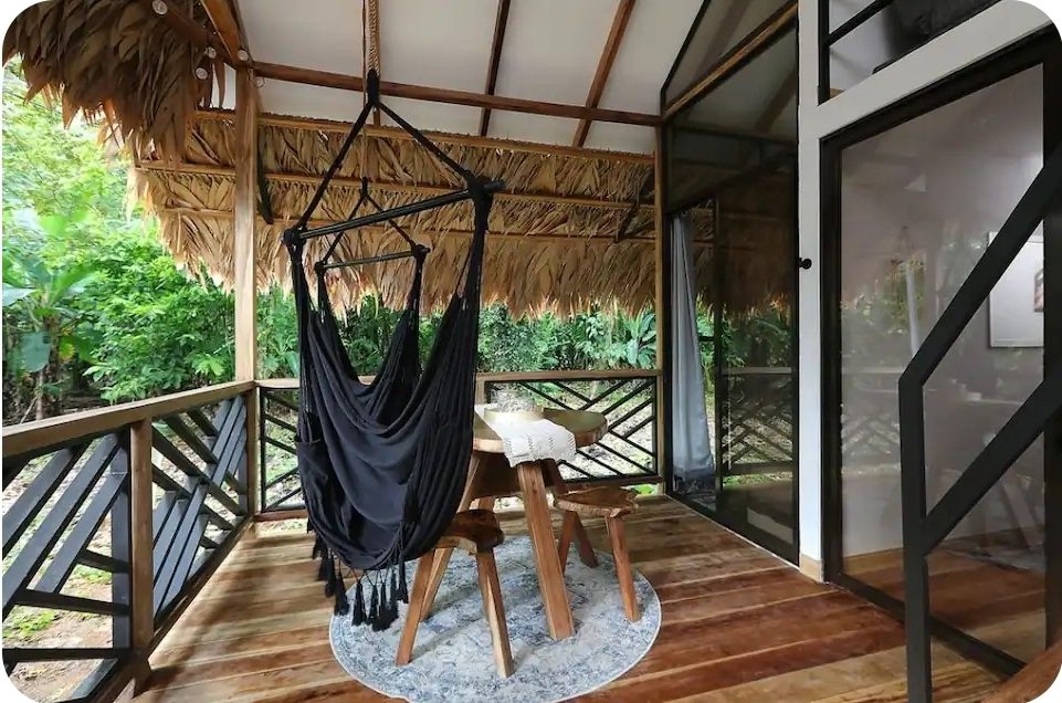 Bungalow deck with hanging hammock chair and jungle view