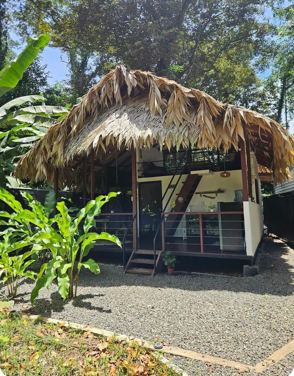 Front view of the first jungle bungalow raised on stilts with a thatched roof