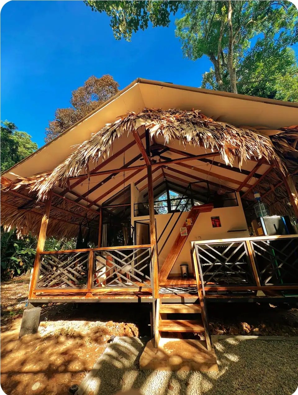 Front view of the second jungle bungalow beneath its thatched roof