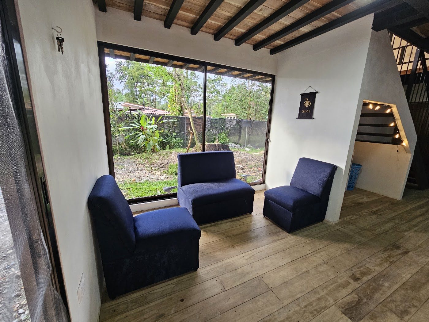 Lounge seating area with blue armchairs and wide windows