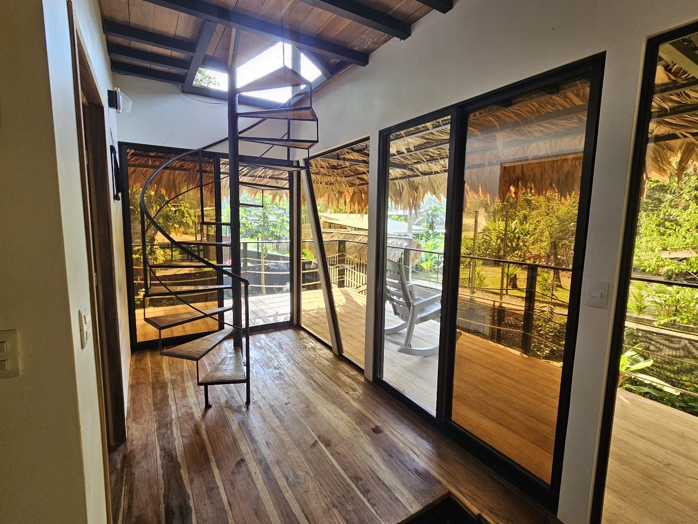 Interior staircase and hardwood floors opening onto the deck