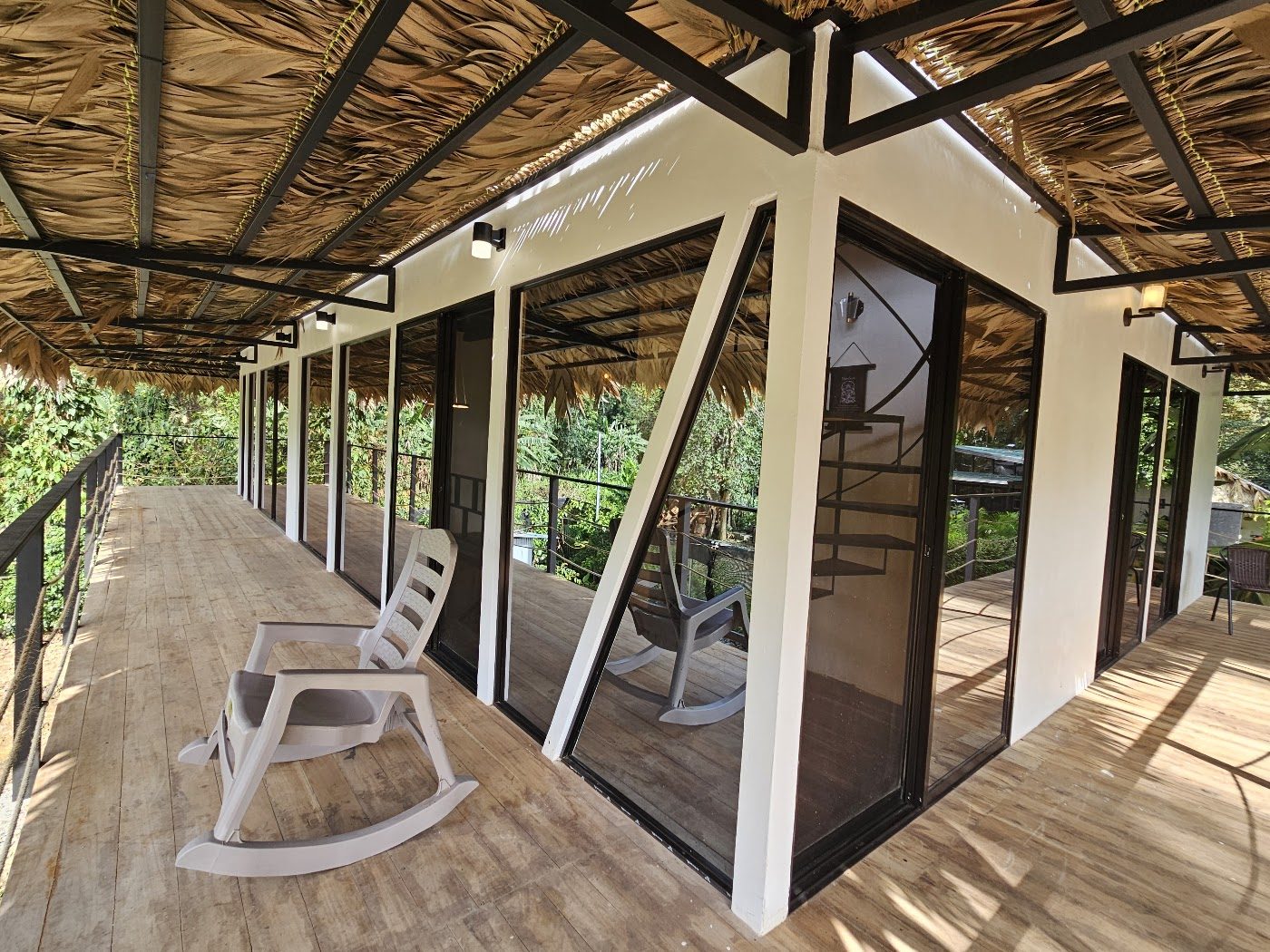 Covered veranda with rocking chairs overlooking the garden