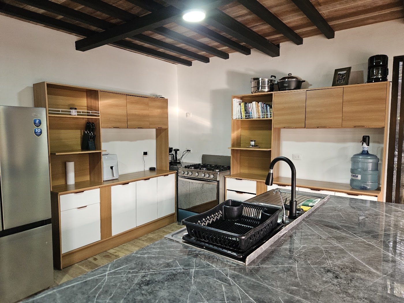 Modern kitchen with marble island and full appliances